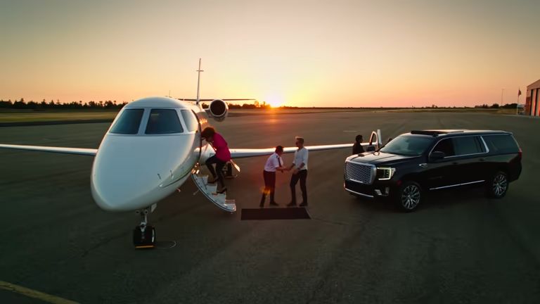 EMT Limo chauffeur with luxury black SUV at Dallas Fort Worth airport