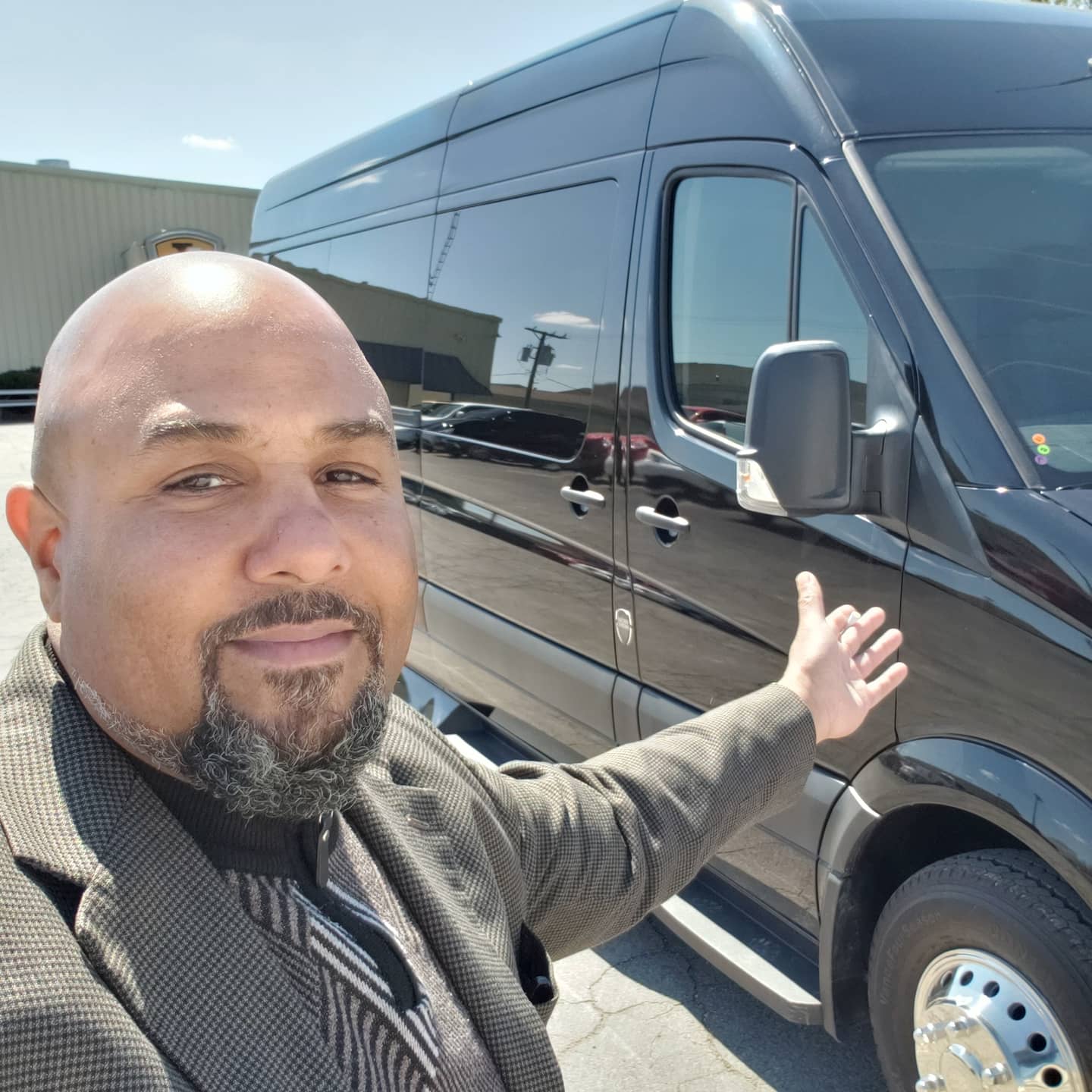 EMT Limo owner Michael Lindsey with a black Sprinter van used for group trips from DFW to Waco